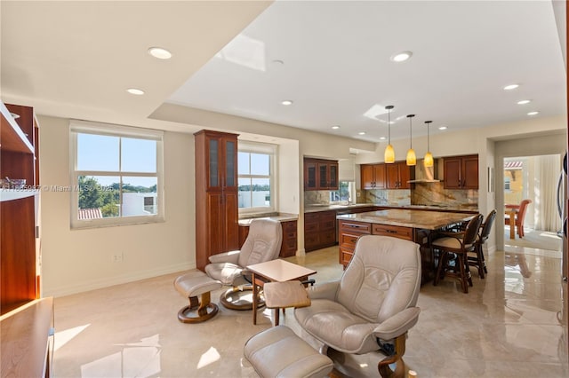 610 Valencia Ave Unit 503, Coral Gables, FL 33134 - kitchen featuring a kitchen island, wall chimney exhaust hood, plenty of natural light, recessed lighting, and tasteful backsplash