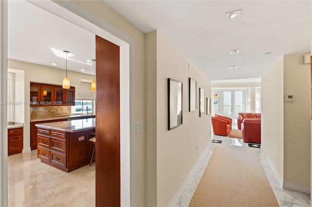 610 Valencia Ave Unit 503, Coral Gables, FL 33134 - hallway with light marble finish flooring, a sink, baseboards, and recessed lighting