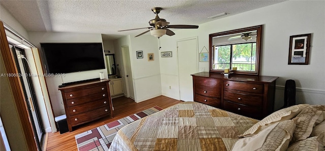 15545 SW 110th Ter, Miami, FL 33196 - bedroom featuring wood finished floors, a textured ceiling, and a ceiling fan