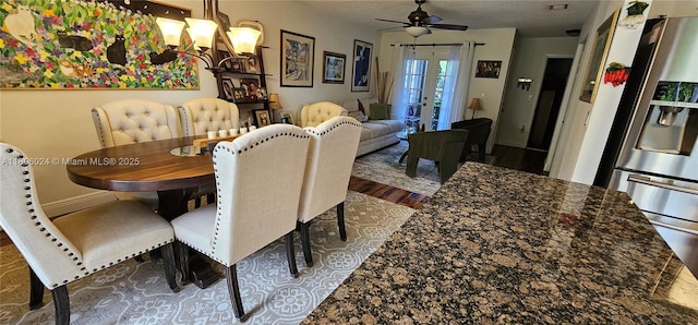 15545 SW 110th Ter, Miami, FL 33196 - dining area with dark wood finished floors, a ceiling fan, and a chandelier