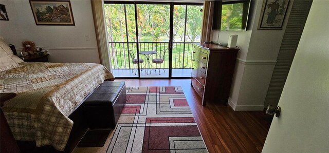 15545 SW 110th Ter, Miami, FL 33196 - bedroom featuring multiple windows, wood finished floors, and access to outside