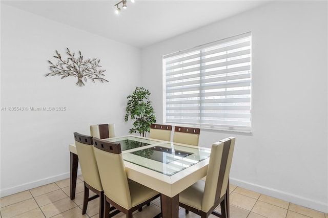 dining room with tile patterned floors and baseboards