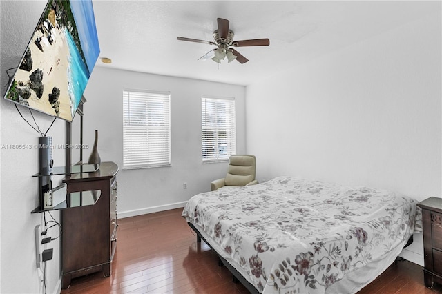 bedroom featuring dark wood finished floors, baseboards, and a ceiling fan