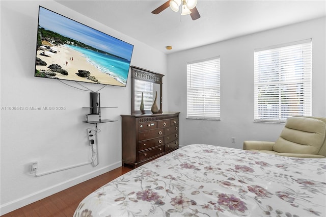 bedroom featuring baseboards, dark wood-style flooring, and ceiling fan