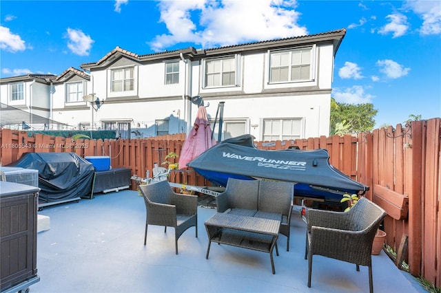 view of patio featuring an outdoor hangout area, a fenced backyard, and area for grilling