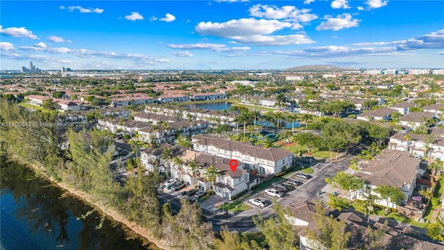 aerial view of property's location featuring a nearby body of water and nearby suburban area
