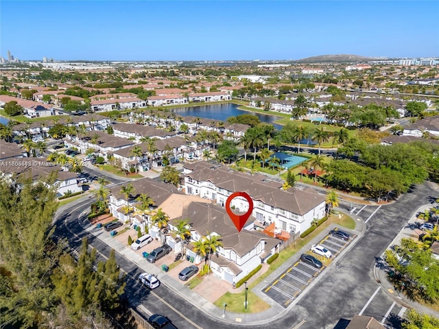 aerial view of property's location with a large body of water and nearby suburban area