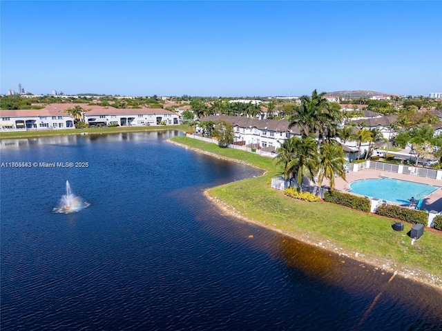 aerial view of residential area with a large body of water and a pool