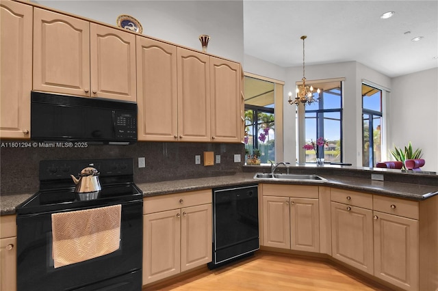 2701 Edgewater Ct, Weston, FL 33332 - kitchen with black appliances, a sink, a chandelier, a peninsula, and backsplash
