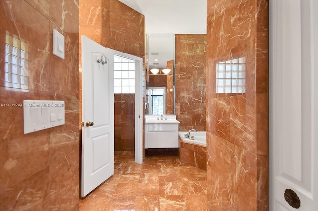 2701 Edgewater Ct, Weston, FL 33332 - bathroom with tile walls, marble finish floors, a bath, and vanity