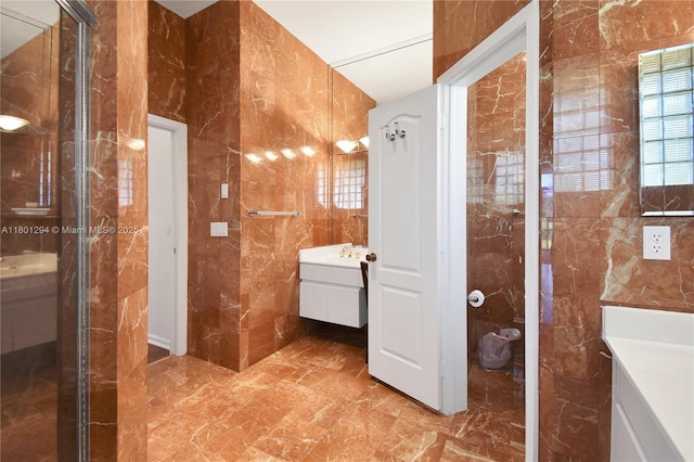 2701 Edgewater Ct, Weston, FL 33332 - full bath featuring tile walls, vanity, marble tiled flooring, and a shower with door