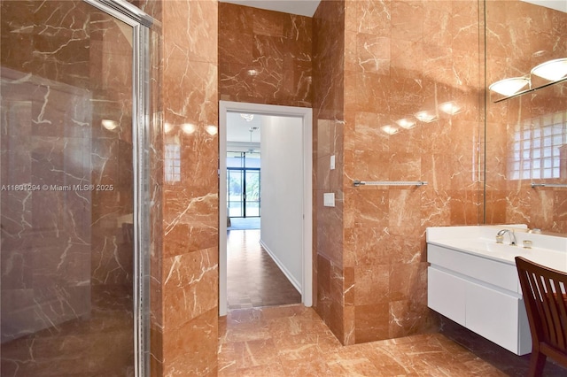 2701 Edgewater Ct, Weston, FL 33332 - full bathroom featuring a marble finish shower, tile walls, vanity, and marble tiled flooring