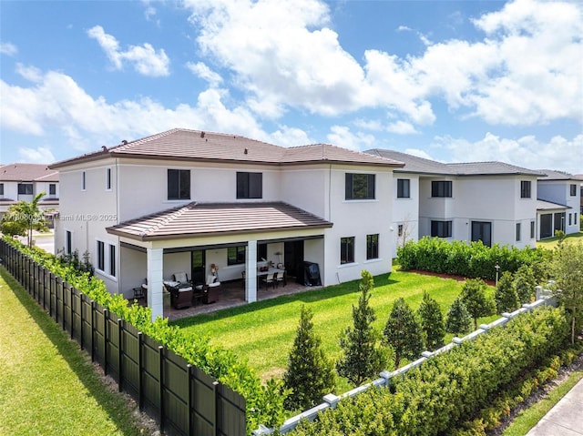 back of property featuring an outdoor living space, a patio, a tile roof, and stucco siding
