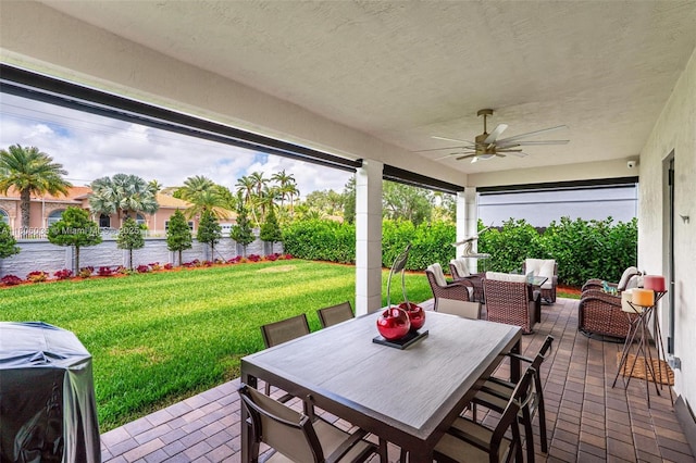 view of patio featuring a ceiling fan, outdoor dining space, and a grill
