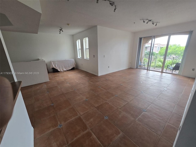 6520 NW 114th Ave Unit 1637, Doral, FL 33178 - tiled empty room with track lighting and baseboards