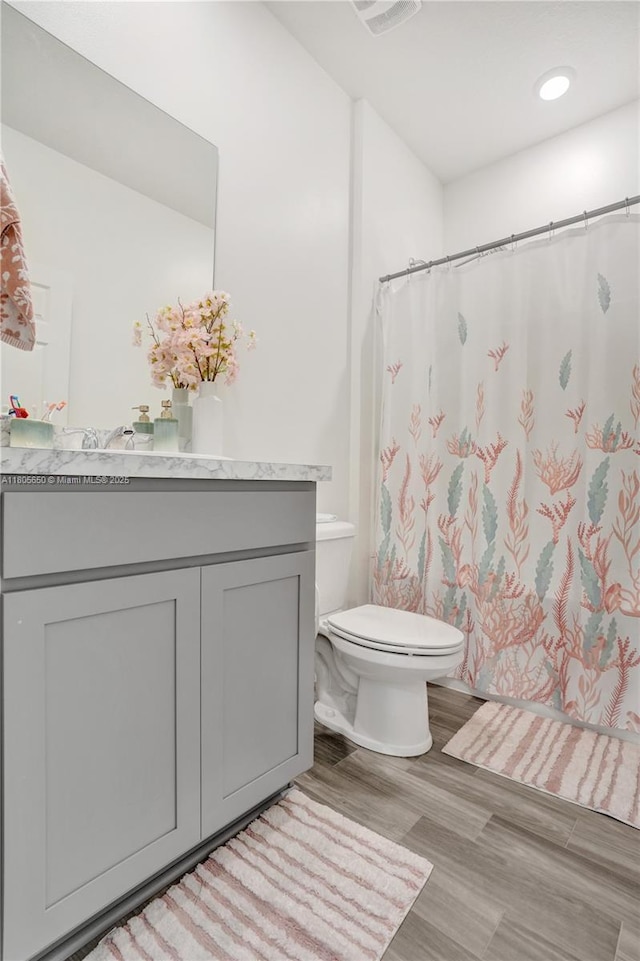 434 SW Namoit Pl, Port St Lucie, FL 34953 - full bath featuring toilet, vanity, wood finished floors, and a shower with curtain
