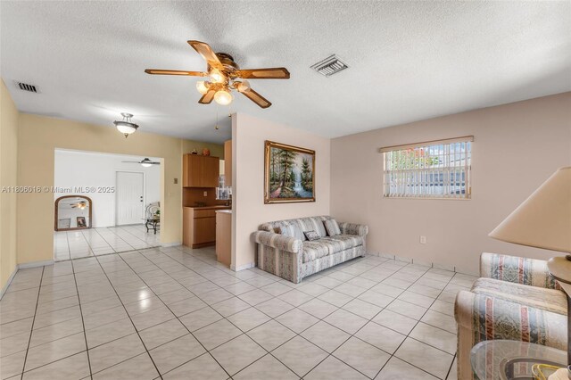 4230 SW 97th Pl, Miami, FL 33165 - living area featuring a ceiling fan, light tile patterned flooring, and a textured ceiling
