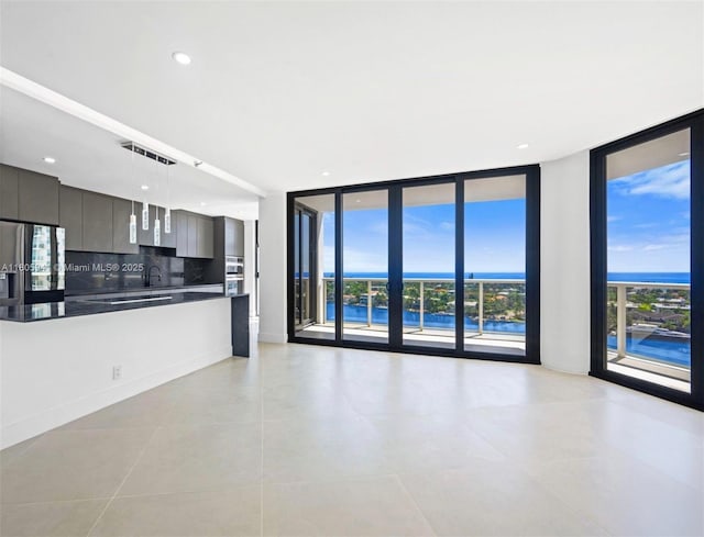 20281 E Country Club Dr Unit 1008, Aventura, FL 33180 - unfurnished living room with floor to ceiling windows, a sink, light tile patterned floors, and recessed lighting