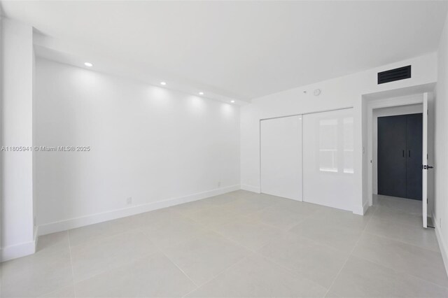 20281 E Country Club Dr Unit 1008, Aventura, FL 33180 - unfurnished bedroom with a closet, light tile patterned floors, recessed lighting, and baseboards