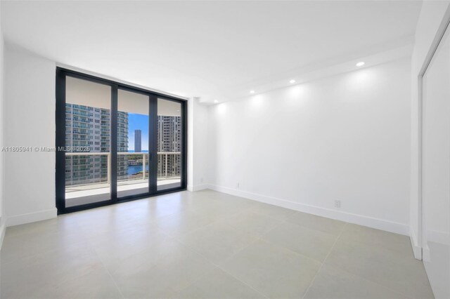 20281 E Country Club Dr Unit 1008, Aventura, FL 33180 - unfurnished room with a wall of windows, baseboards, and recessed lighting