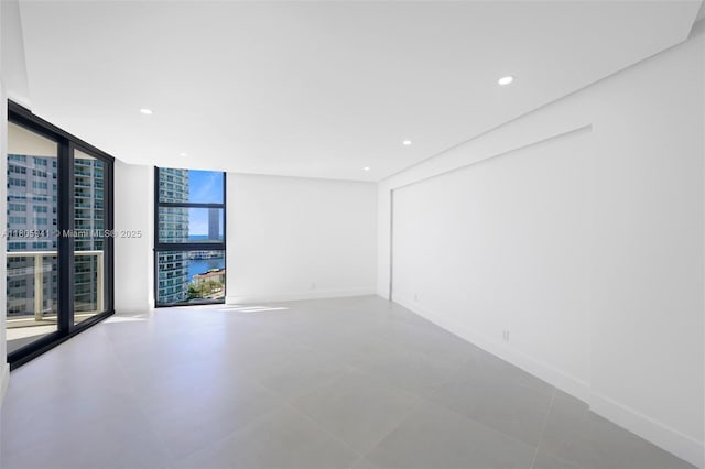 20281 E Country Club Dr Unit 1008, Aventura, FL 33180 - tiled spare room featuring floor to ceiling windows, recessed lighting, and baseboards