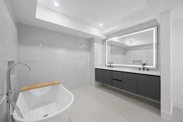 20281 E Country Club Dr Unit 1008, Aventura, FL 33180 - full bath with tile patterned flooring, double vanity, a freestanding tub, recessed lighting, and a tray ceiling