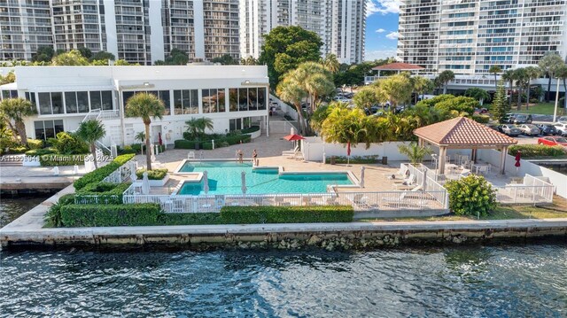 20281 E Country Club Dr Unit 1008, Aventura, FL 33180 - back of house with a gazebo, a water view, a patio, and a community pool