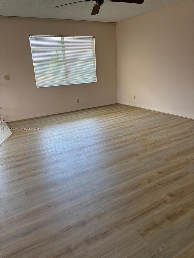 235 E Burgundy E Unit 235, Delray Beach, FL 33484 - unfurnished room featuring a ceiling fan, wood finished floors, and baseboards