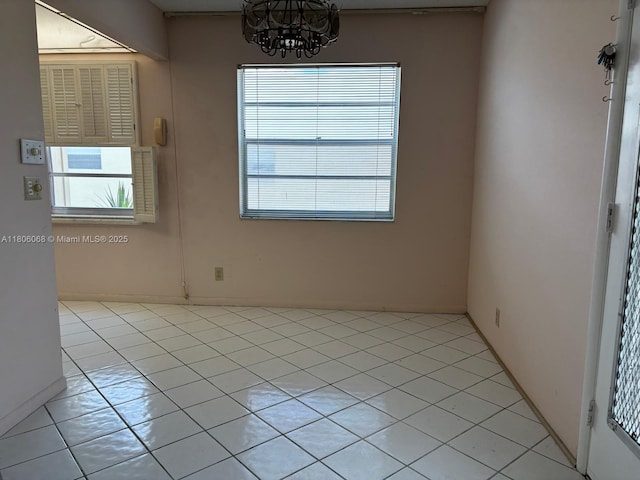 235 E Burgundy E Unit 235, Delray Beach, FL 33484 - spare room with a chandelier and light tile patterned flooring