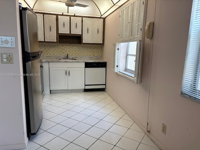 235 E Burgundy E Unit 235, Delray Beach, FL 33484 - kitchen featuring dishwasher, light countertops, decorative backsplash, a sink, and freestanding refrigerator