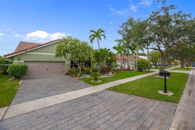 596 NW 164th Ave, Pembroke Pines, FL 33028 - view of front of property with decorative driveway, a front yard, a garage, stucco siding, and a tiled roof