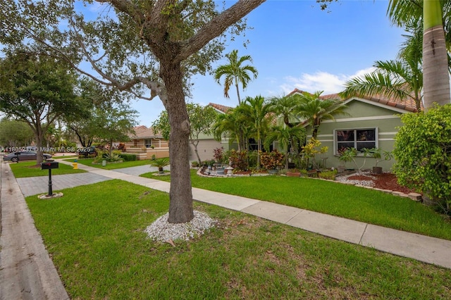 596 NW 164th Ave, Pembroke Pines, FL 33028 - view of front of home with stucco siding, a front lawn, and a tiled roof