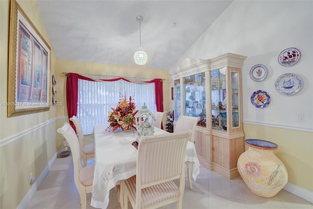 596 NW 164th Ave, Pembroke Pines, FL 33028 - tiled dining space with lofted ceiling and a chandelier