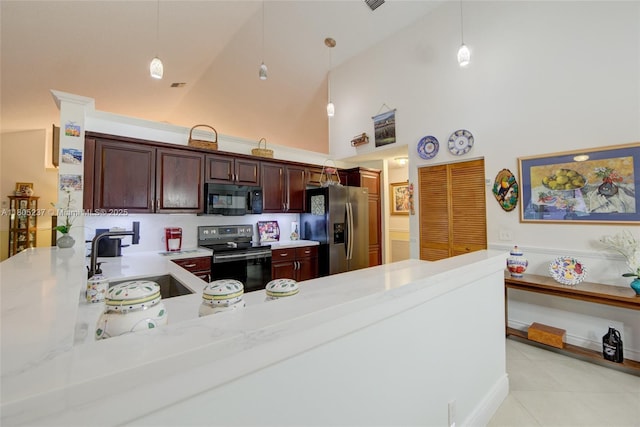 596 NW 164th Ave, Pembroke Pines, FL 33028 - kitchen with appliances with stainless steel finishes, high vaulted ceiling, light countertops, hanging light fixtures, and a kitchen bar
