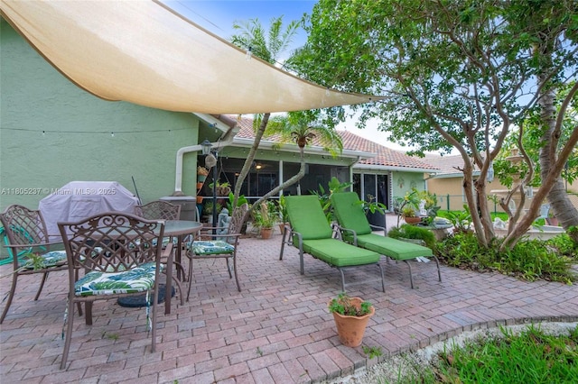 596 NW 164th Ave, Pembroke Pines, FL 33028 - view of patio / terrace featuring outdoor dining area and a sunroom