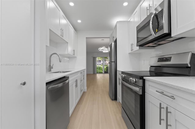 1300 SW 124th Ter Unit 107P, Pembroke Pines, FL 33027 - kitchen with stainless steel appliances, a sink, decorative backsplash, light wood-style floors, and recessed lighting