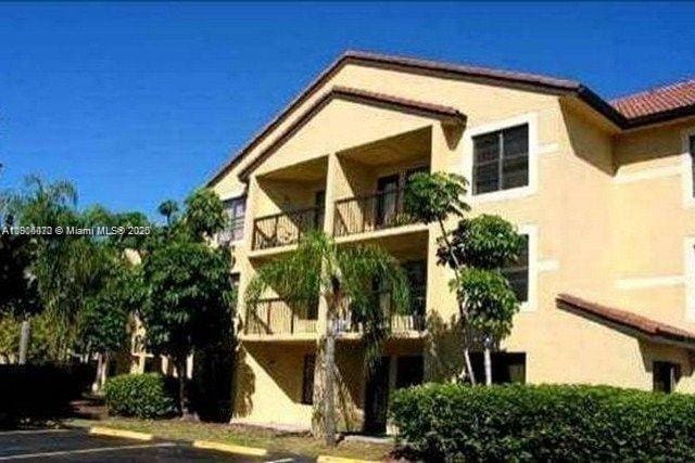4441 W Mcnab Rd Unit 21, Pompano Beach, FL 33069 - back of property with a balcony, stucco siding, and uncovered parking
