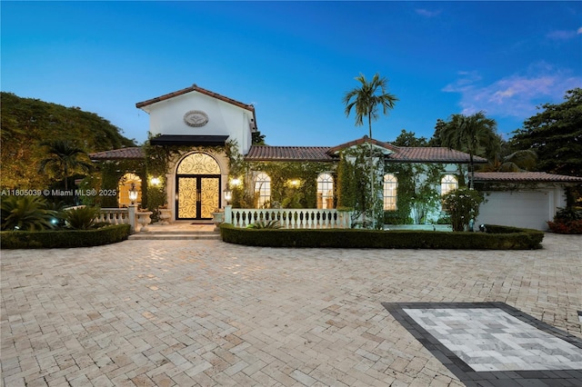 12300 Old Cutler Rd, Pinecrest, FL 33156 - mediterranean / spanish-style home featuring an attached garage