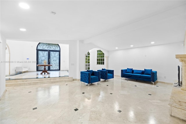 12300 Old Cutler Rd, Pinecrest, FL 33156 - unfurnished living room with baseboards, arched walkways, recessed lighting, a fireplace, and tile patterned flooring