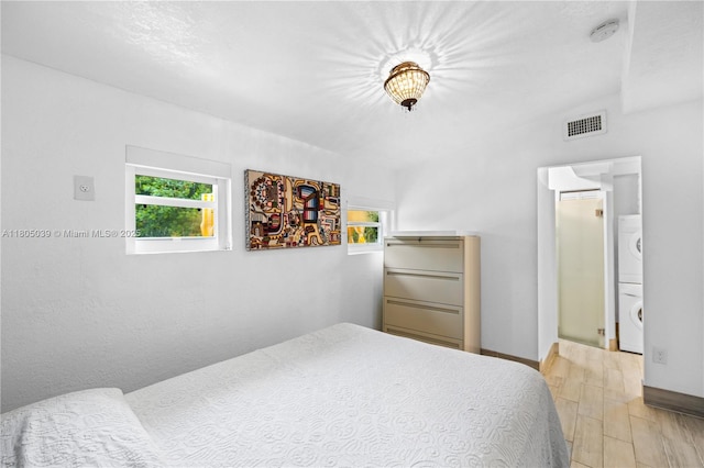 12300 Old Cutler Rd, Pinecrest, FL 33156 - bedroom featuring estacked washer and dryer and baseboards