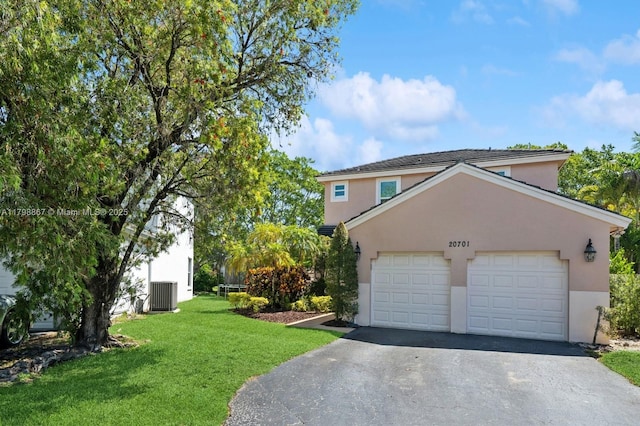 20701 NW 3rd Ct, Pembroke Pines, FL 33029 - view of front facade featuring cooling unit, stucco siding, asphalt driveway, and a front yard