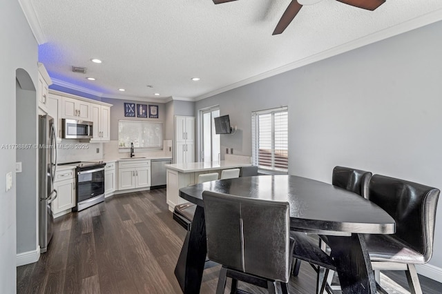 20701 NW 3rd Ct, Pembroke Pines, FL 33029 - dining space featuring a ceiling fan, a textured ceiling, ornamental molding, dark wood-type flooring, and recessed lighting