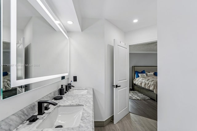 20701 NW 3rd Ct, Pembroke Pines, FL 33029 - ensuite bathroom featuring baseboards, recessed lighting, double vanity, and wood finished floors