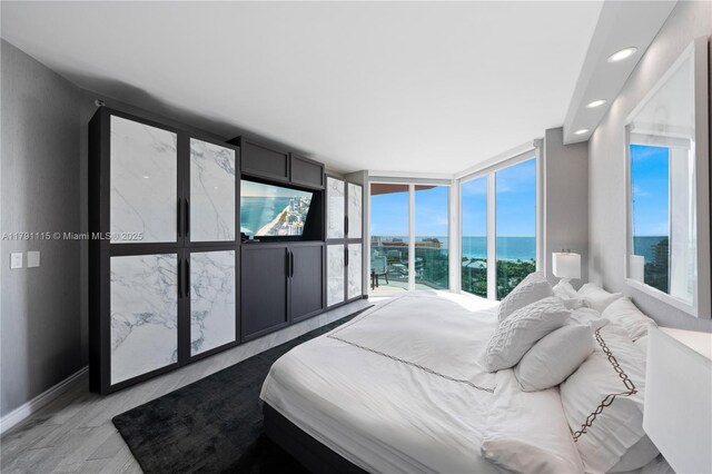 300 S Pointe Dr Unit 1505, Miami Beach, FL 33139 - bedroom featuring multiple windows, light wood-type flooring, recessed lighting, and baseboards
