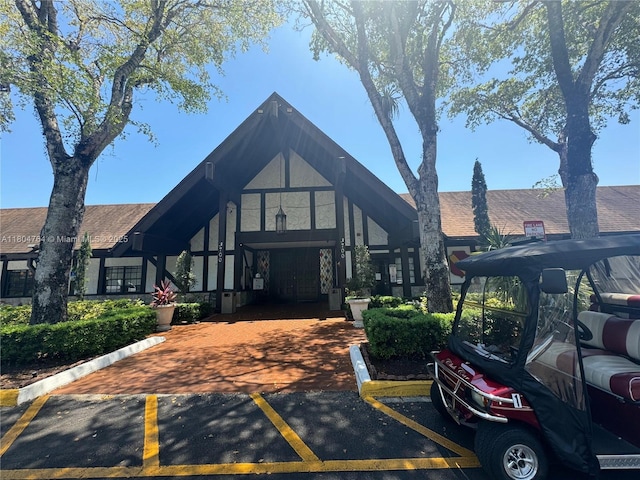 3660 Inverrary Dr Unit 2W, Lauderhill, FL 33319 - tudor home featuring uncovered parking, central AC, and a shingled roof