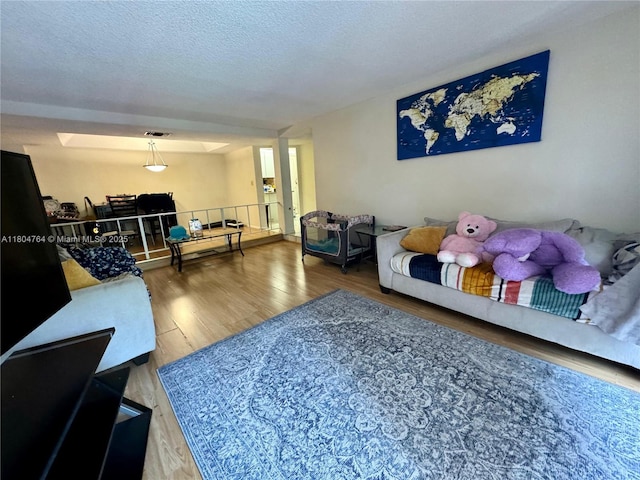 3660 Inverrary Dr Unit 2W, Lauderhill, FL 33319 - living room with wood finished floors and a textured ceiling