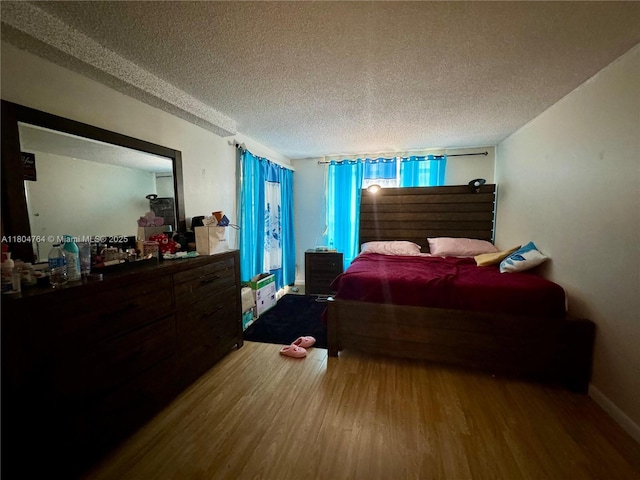 3660 Inverrary Dr Unit 2W, Lauderhill, FL 33319 - bedroom with wood finished floors and a textured ceiling
