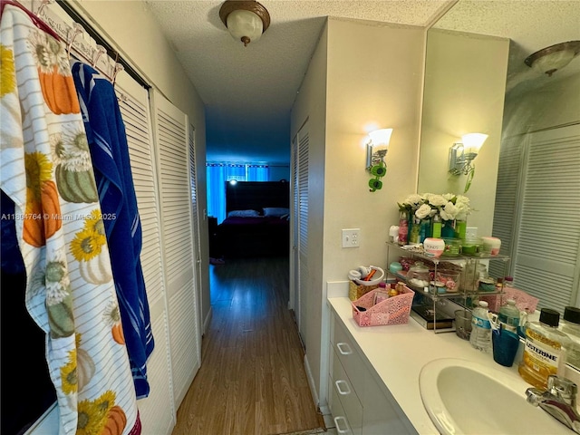 3660 Inverrary Dr Unit 2W, Lauderhill, FL 33319 - hallway with wood finished floors, a textured ceiling, and a sink