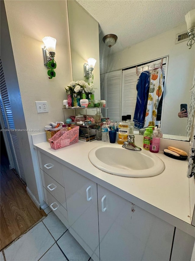 3660 Inverrary Dr Unit 2W, Lauderhill, FL 33319 - bathroom featuring vanity, a textured ceiling, and tile patterned flooring