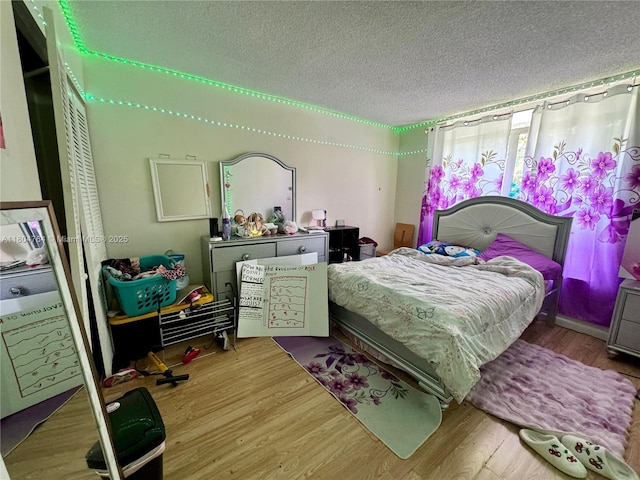 3660 Inverrary Dr Unit 2W, Lauderhill, FL 33319 - bedroom featuring a textured ceiling and wood finished floors